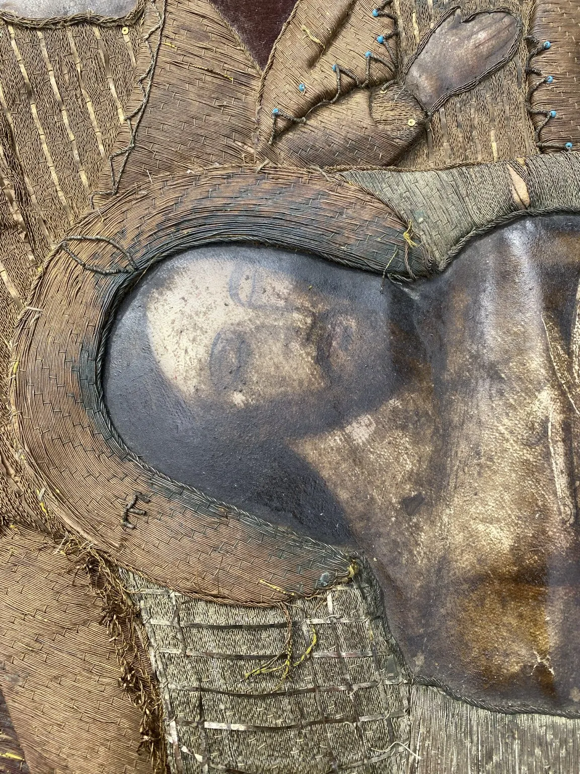 Before restoration. The face of Christ beneath the darkened coating.