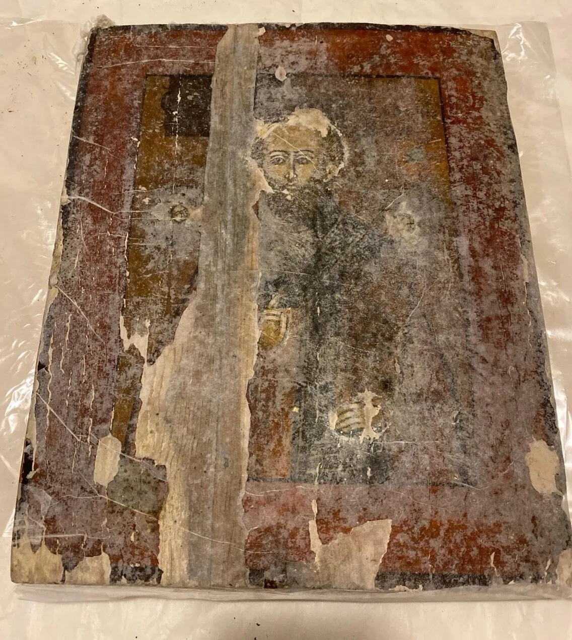 During restoration. Protective facing of the painting.