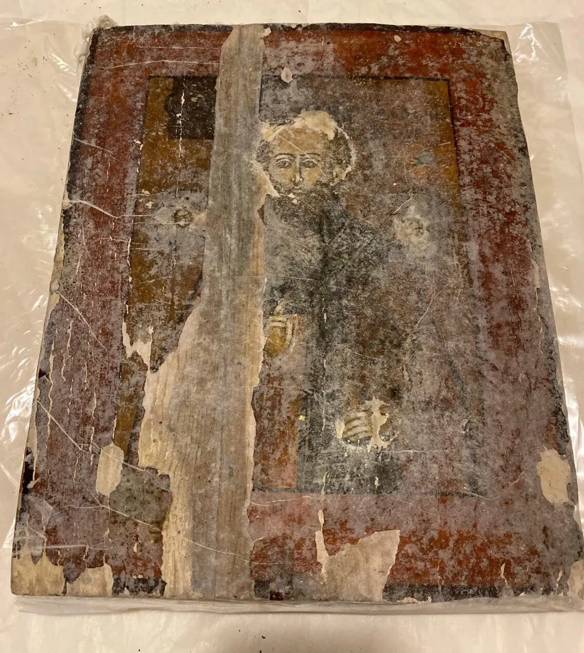 During restoration. Protective facing of the painting.