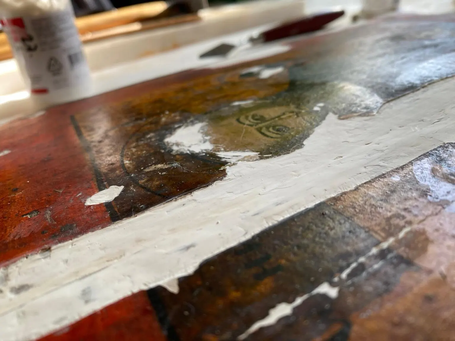 During restoration. Filling ground losses along the board joint.