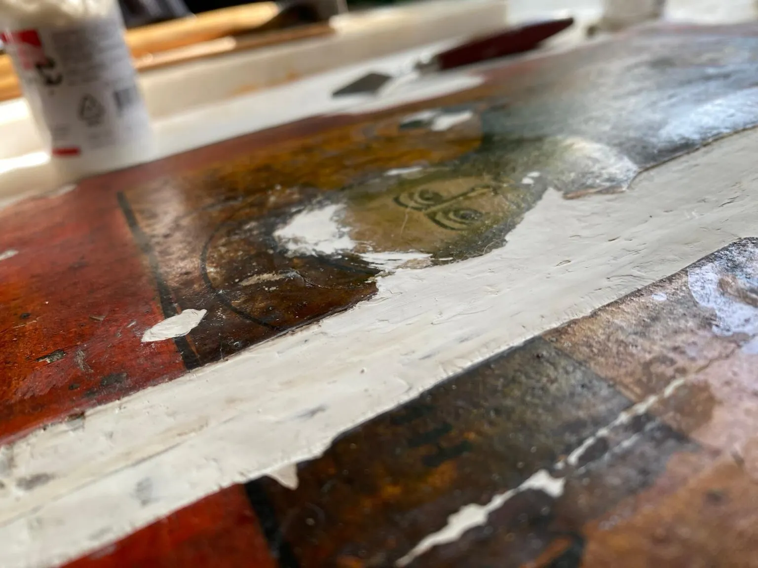 During restoration. Filling ground losses along the board joint.