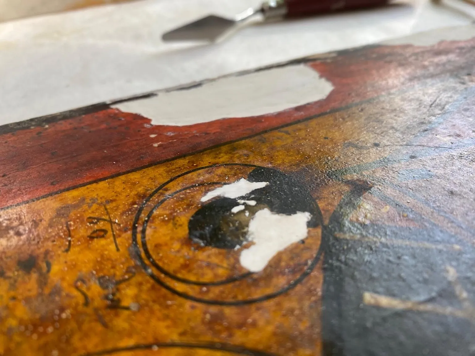 During restoration. Local filling of ground losses in the painted area.